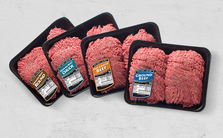 Assorted retail trays of ground beef with different label types arranged side by side.
