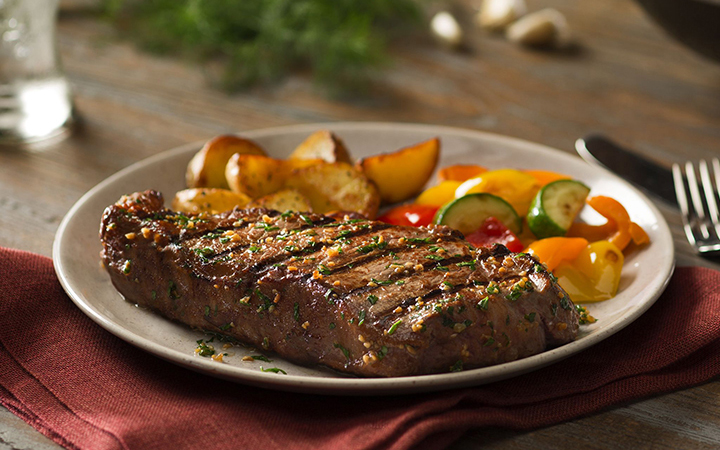 Plate with grilled steak, roasted potatoes, and mixed vegetables