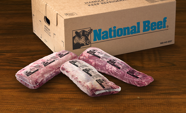 National Beef box with three vacuum-packed Certified Angus Beef primals displayed in front on a wooden surface