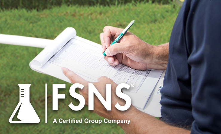 Person filling out inspection form on clipboard with FSNS logo