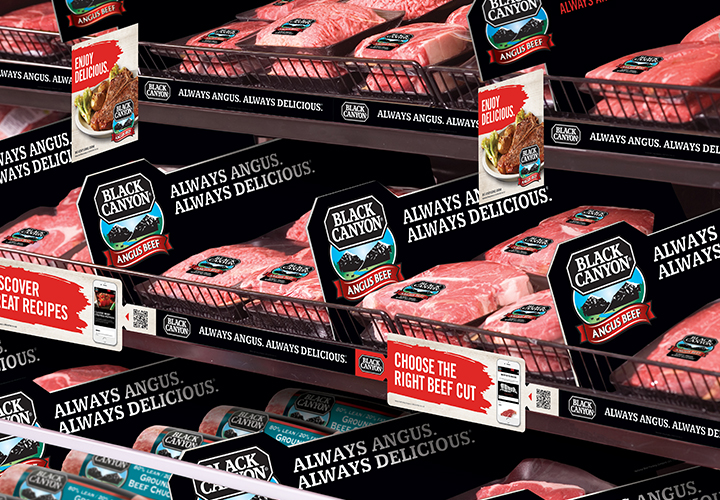 Black Canyon Angus Beef packages in a meat case.