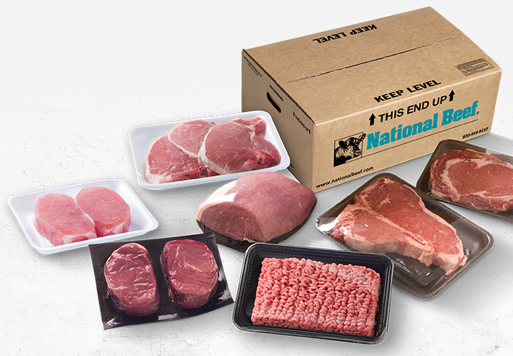 Assorted packaged meat cuts, including steaks, pork chops, and ground beef, arranged in front of a National Beef shipping box.