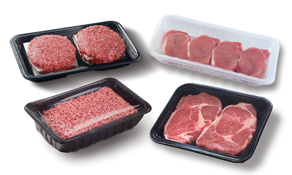 Assorted packaged meat cuts including steaks, ground beef, and pork chops in trays.