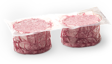 Vacuum-sealed stack of raw ground beef patties