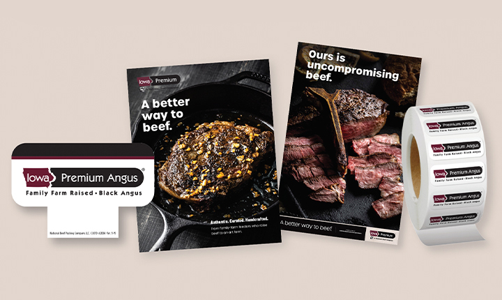Iowa Premium Angus point-of-sale materials including beef posters, signage, and a roll of branded labels