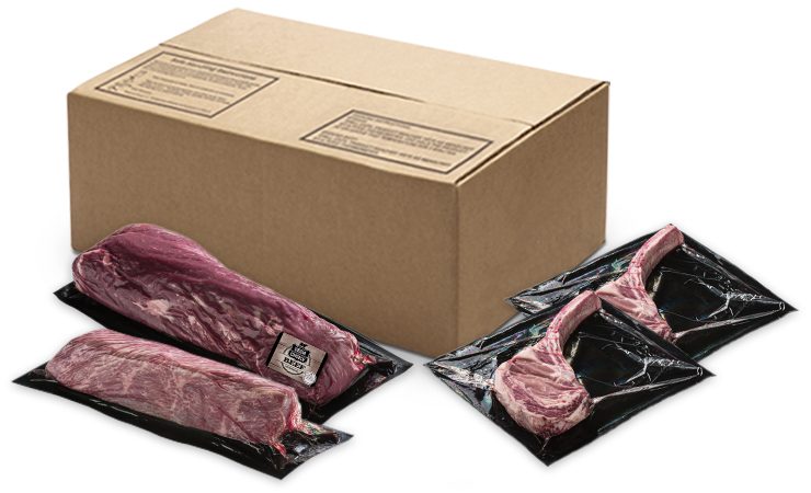 Box of vacuum-sealed specialty beef cuts with several individually packaged steaks arranged in front.
