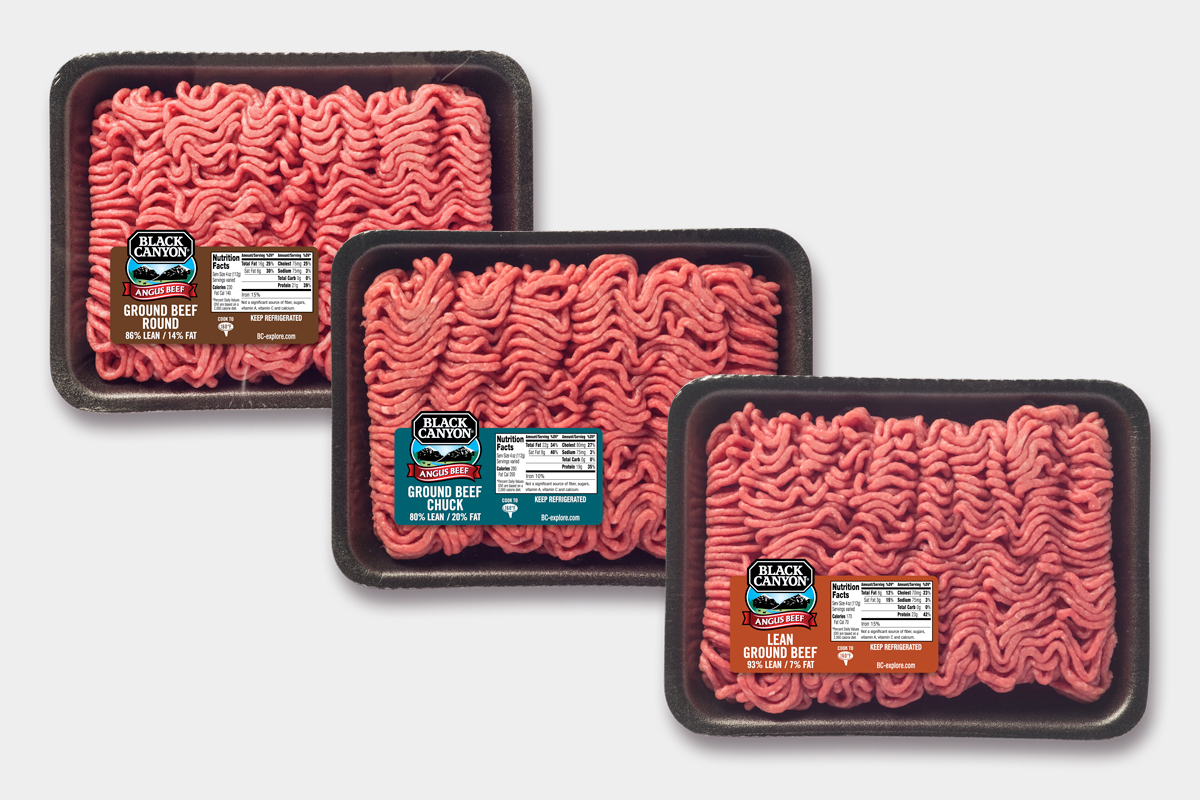 Three trays of Black Canyon fresh ground beef in black overwrap packages