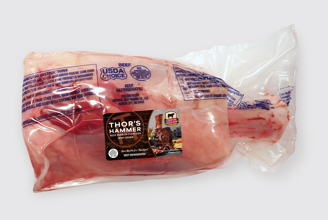 Large vacuum-sealed bone-in beef shank labeled “Thor’s Hammer” with Certified Angus Beef branding.