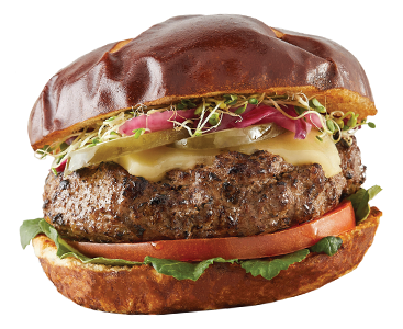 Gourmet beef burger with cheese, onions, tomato, and lettuce on a pretzel bun.