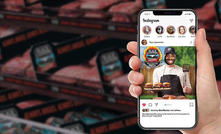 Person using a smartphone to browse beef promotions in front of a meat display.