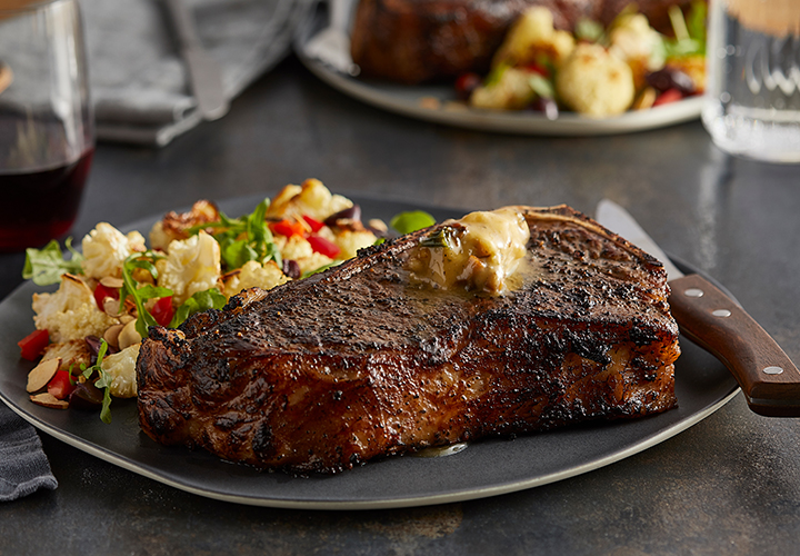 Grilled steak with vegetables on a plate.
