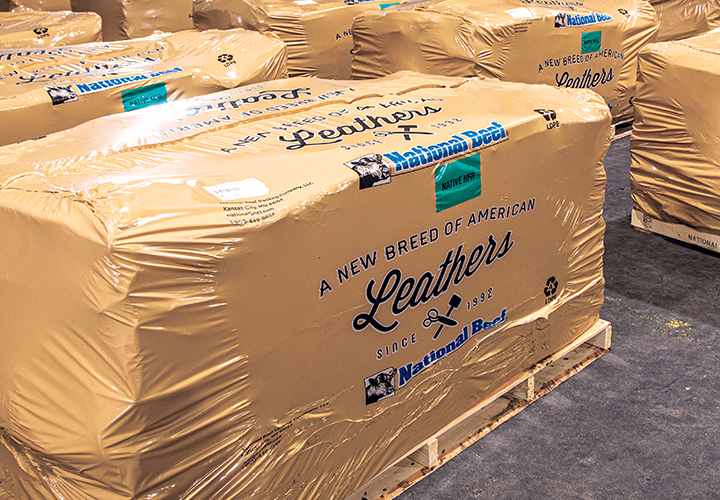 Pallet stacks of wrapped leather bundles labeled National Beef Leathers.