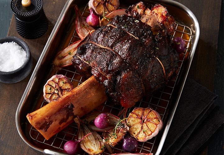 Roasted Thor’s Hammer beef shank in a pan with roasted garlic and onions.