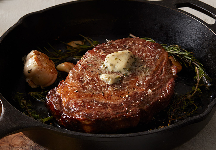 Grilled steak in a cast iron skillet.