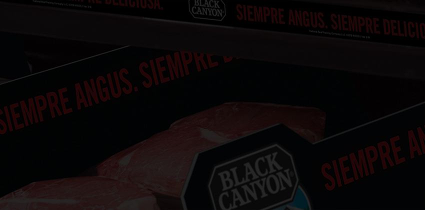 Shelves of packaged Black Canyon Angus Beef with bilingual rail strips reading always angus always delicious and siempre angus siempre deliciosa