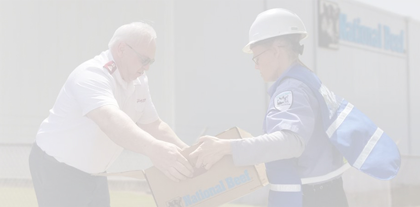 Two workers holding a box for charity.