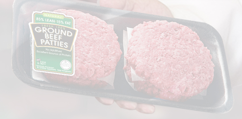 Person holding a package of two raw ground-beef patties.