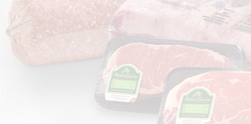 Box of Natural Angus Beef with packaged steaks beside it, labeled with product claims