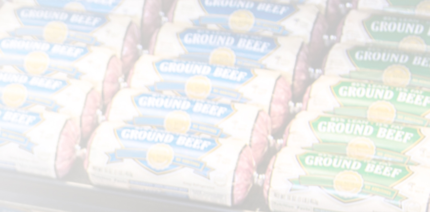 Close-up row of packaged ground beef chubs in a refrigerated display.