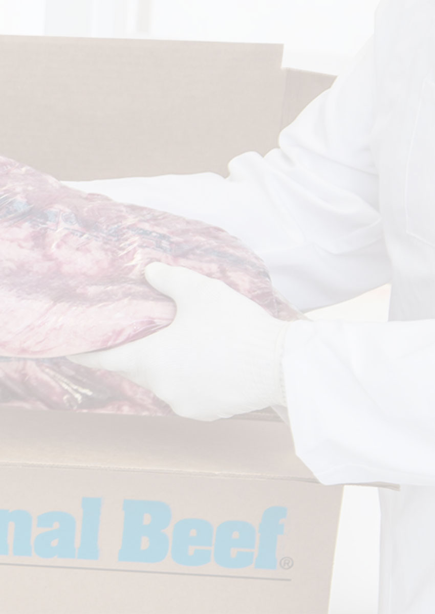 Butcher pulling out a National Beef primal from a National Beef box.